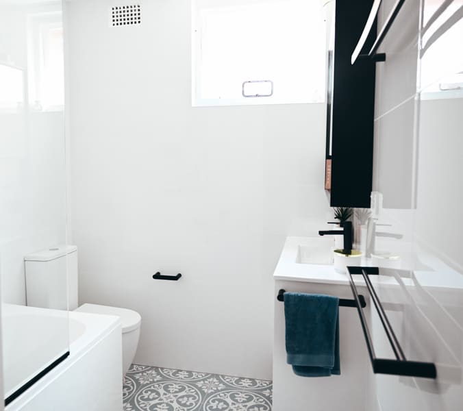 Full-bathroom-renovation-in-Monterey-with-combined-shower-and-bath-completed-by-Nu-Trend-in-Sydney-with-white-tiles