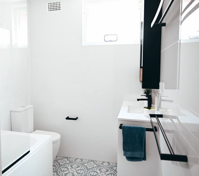 Full bathroom renovation in Monterey with combined shower and bath completed by Nu Trend in Sydney with white tiles