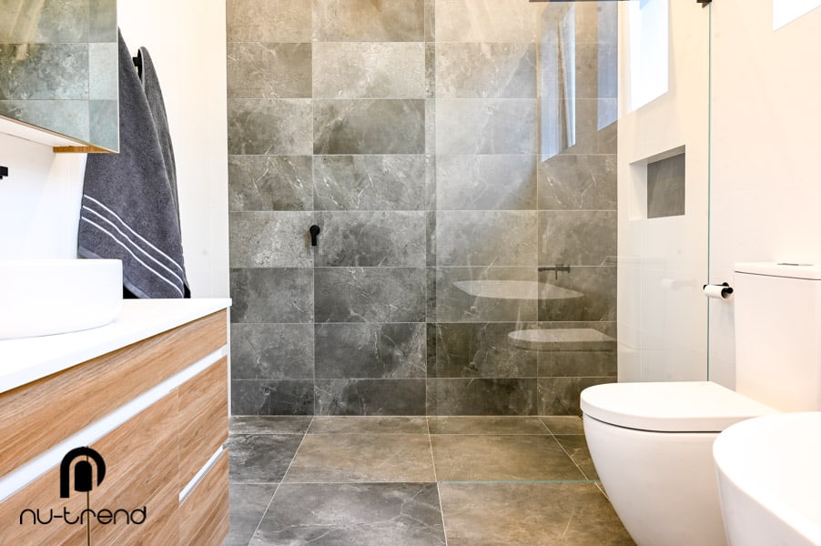 Making a bathroom with bath and shower larger in Sylvania Waters photo Small bathroom renovator install Koko Matt White to wall toilet suite of