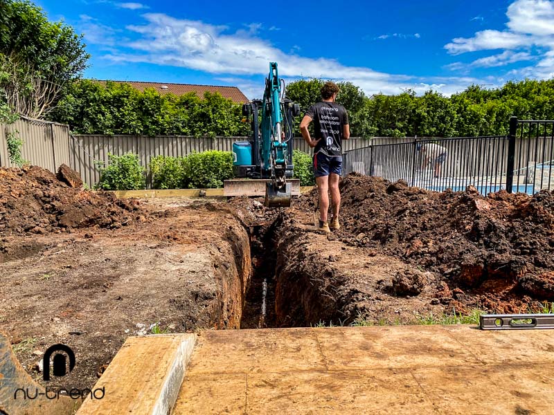 Plumber in Sydney replace illegal sewer pipe work - excavating to relocate plumbing