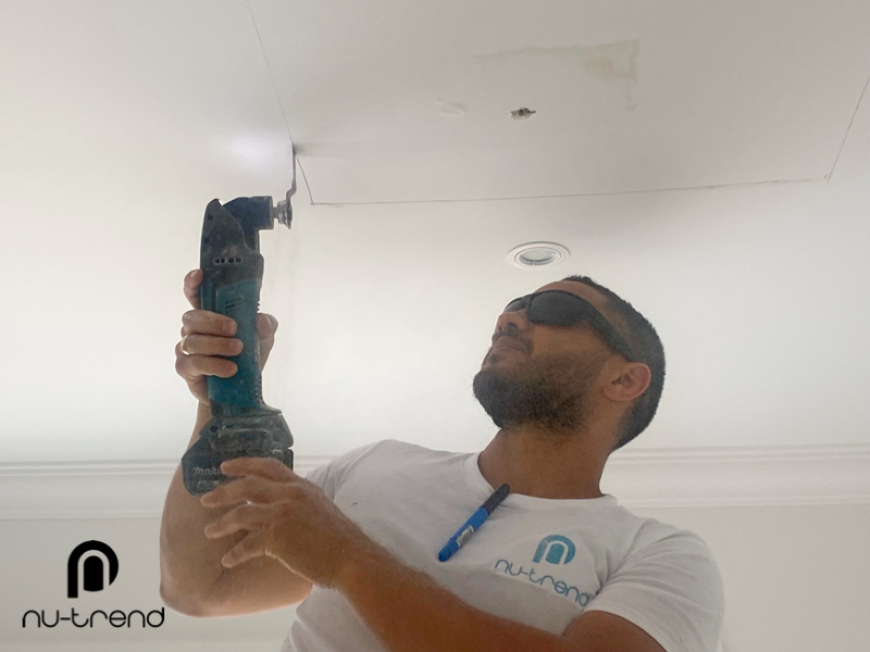 Plumber to repair water leak in upstairs bathroom in Sydney - cutting around the damage