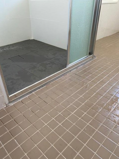 Shower floor tiles are picture framing indicating water proofing was not applied correctly