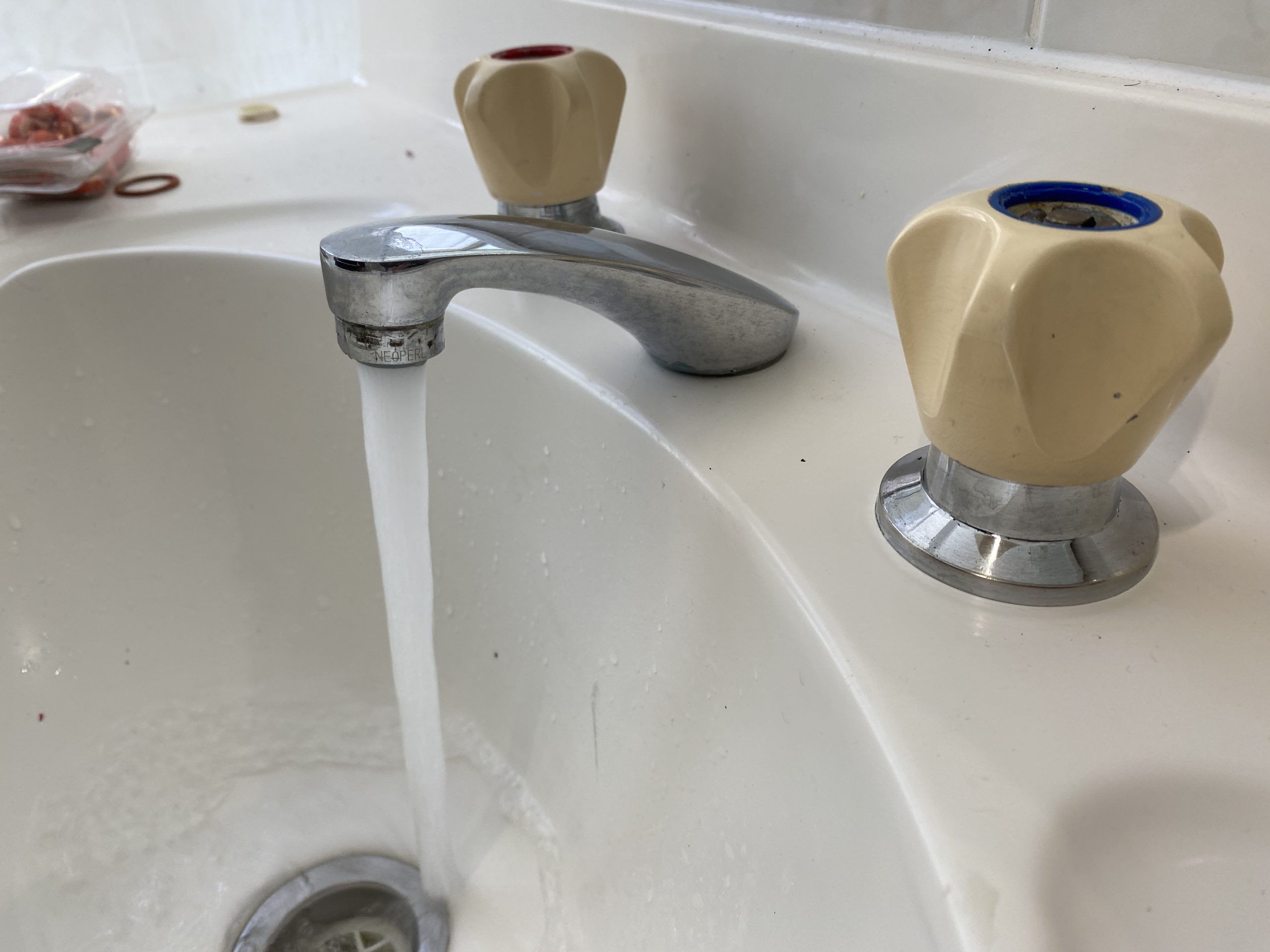 Plumber repaired leaking tap in bathroom scaled